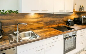 Fridge, stovetop, dishwasher, coffee/tea maker