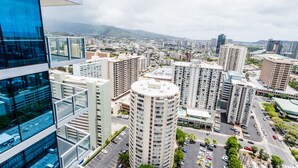 A high-rise building with multiple floors, surrounded by other tall buildings and a cityscape in the background.
