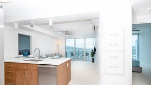A modern kitchen with a central island, built-in cabinets, and a dishwasher.