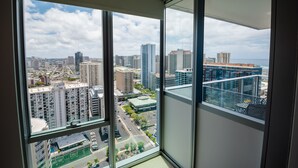 A high-rise building with a view of a cityscape and the ocean.