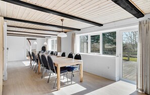 Enjoy group dining or meetings in this well-appointed room with a long dining table and comfortable chairs.