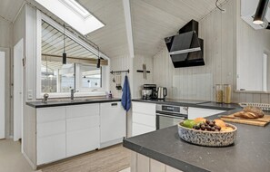 Fridge, stovetop, dishwasher, coffee/tea maker