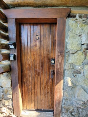Secure entry to this traditional room, featuring a sturdy wooden door with electronic locks.