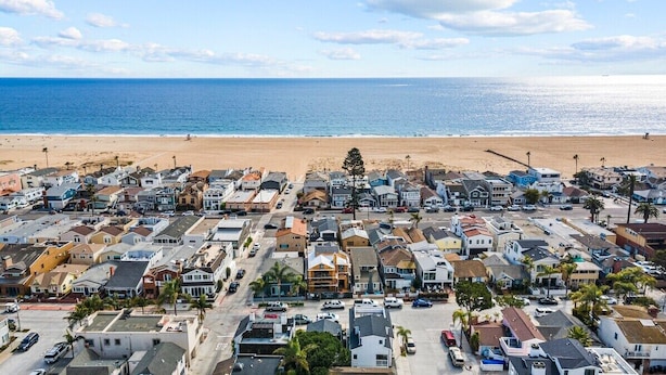 A coastal residential area with houses and a beach.