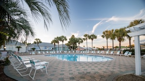 A swimming pool with lounge chairs and palm trees. - Charming Beach Cottage, Beach Chair Service Included. Snowbirds special rates! (Miramar Beach)