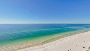 A beach with clear turquoise water and a sandy shore.