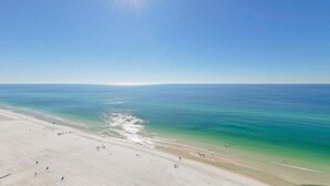 A beach with clear water and a sandy shore.