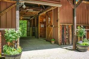 A rustic wooden building with a welcoming sign, a bear warning sign, and a bell.