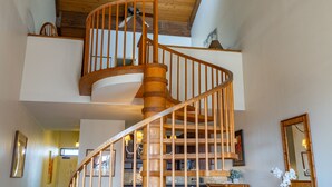 A wooden spiral staircase with a handrail and a ceiling fan. - 🌈Updated OCEANVIEW Kihei Penthouse, Sleeps 6, +Beach Gear🐬 (Kihei)