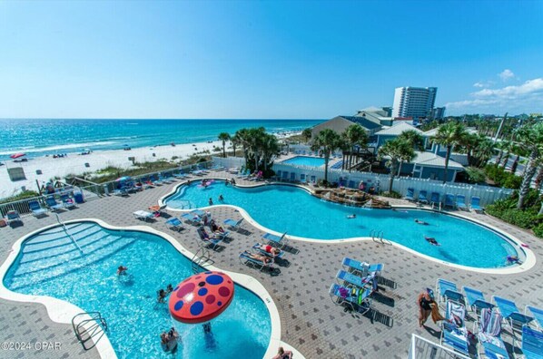 Relax by the pool surrounded by palm trees and enjoy scenic ocean views.