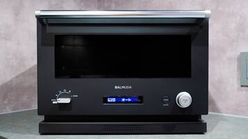 A black Barmuda oven with a digital display, control knobs, and a start/stop button.