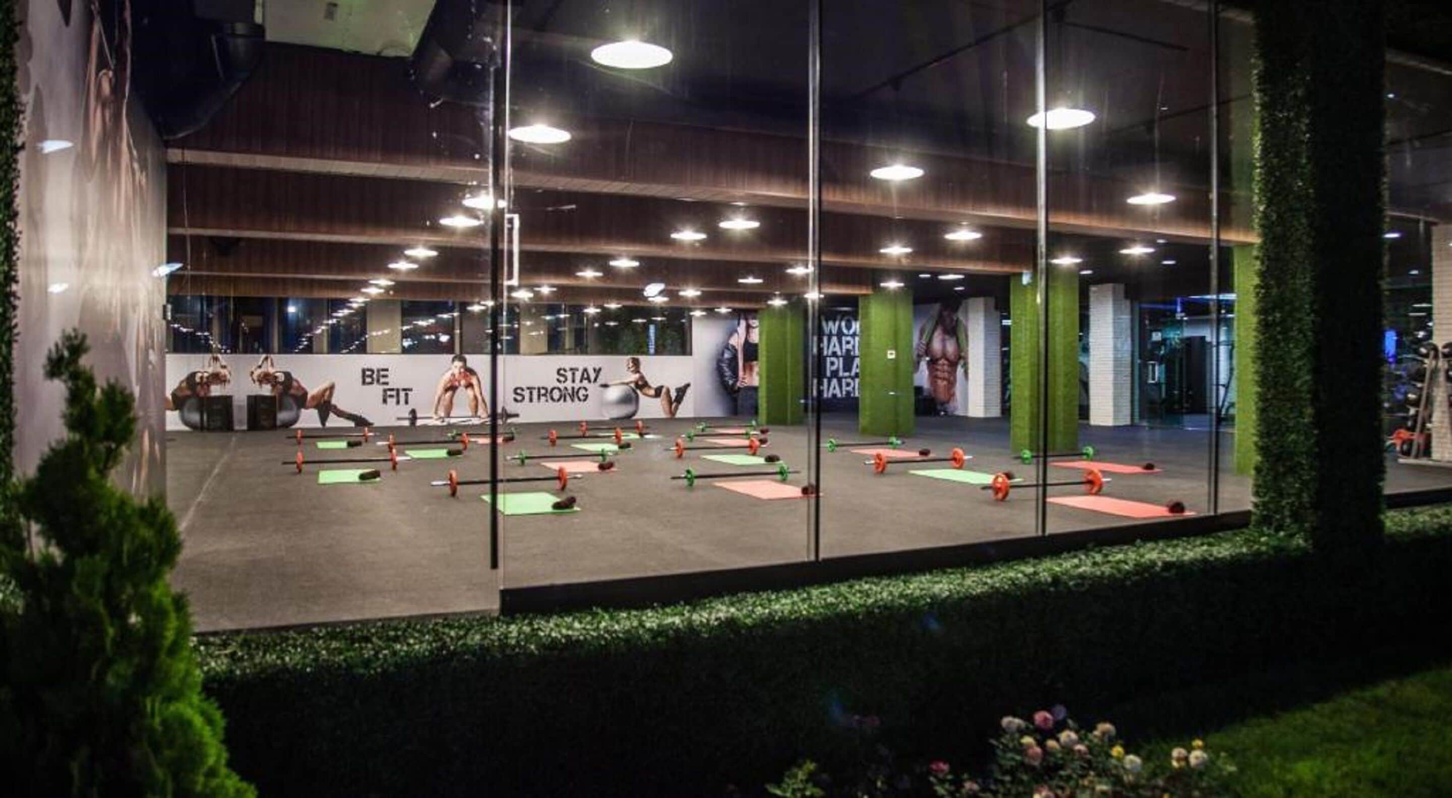 A gym with exercise equipment and motivational posters.