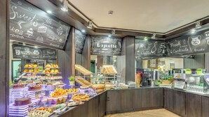 A buffet area with a variety of desserts and pastries, a coffee station, and a chalkboard menu with food options. - Grand Hotel Sveti Vlas (Sveti Vlas)