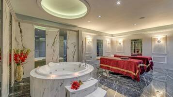 Relax in a serene space with a bathtub and massage tables.