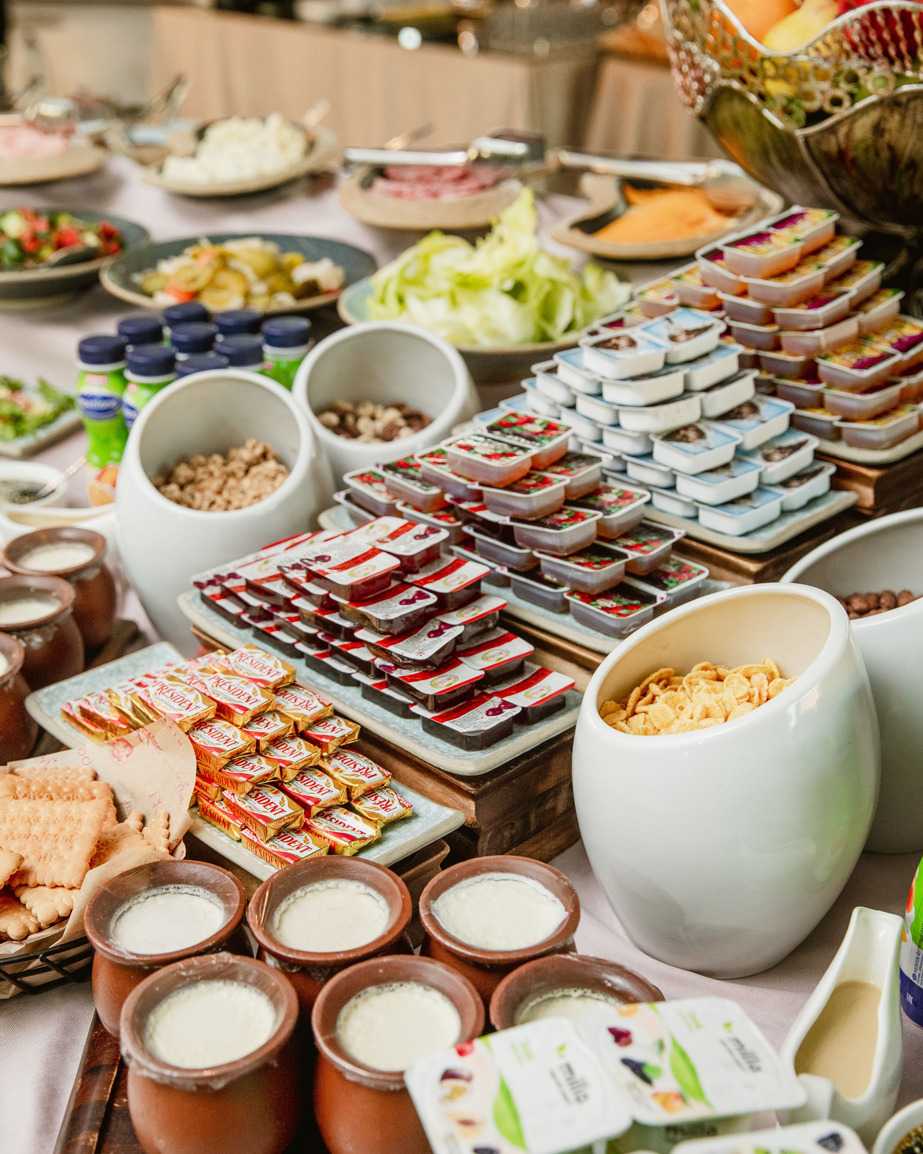 A buffet table with various food items and beverages.