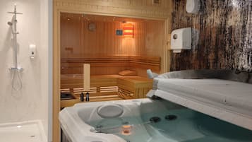 Relax in a serene spa room with a large hot tub and separate shower area.