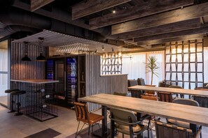 A modern interior with exposed ceilings, industrial-style furniture, and a mix of wooden and metal elements. - Joy 5 Hotel & SPA (Belgrade)