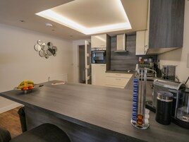 A modern kitchen with a central island, built-in appliances, and a minimalist design.