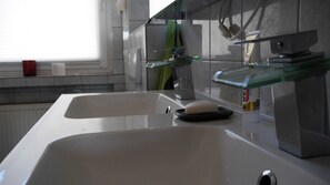 Bathtub, towels, soap, toilet paper