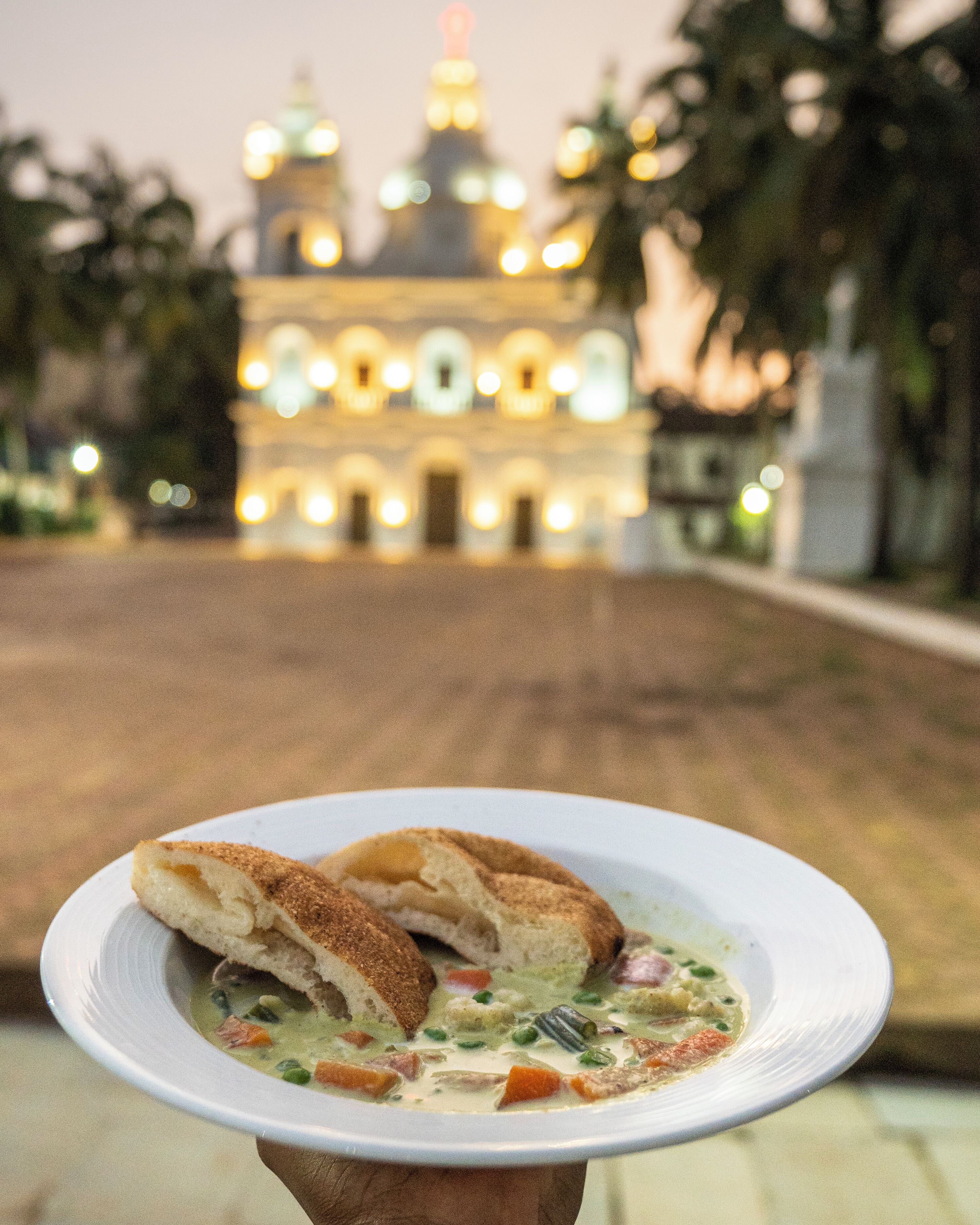 A plate of food with a building in the background.