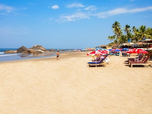 Beach nearby, white sand, beach umbrellas, beach towels
