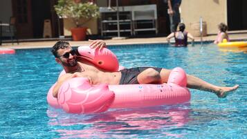 Outdoor pool, open 7:00 AM to 9:00 PM, pool loungers