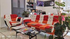 A modern living room with a sofa, coffee table, and a television. - CSI Group - Hotel metropoli (Milan)