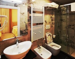 A bathroom with a sink, bidet, and shower. - CSI Group - Hotel metropoli (Milan)