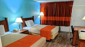 A hotel room with two beds, a desk, a chair, and a telephone. - Howard Johnson BY Wyndham Hannibal (Hannibal)