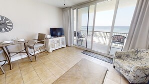Enjoy a comfortable stay with a sofa, dining area, and sliding glass door leading to a balcony with a sea view.