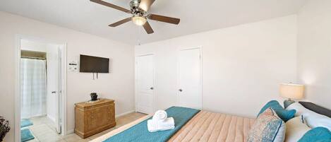 Master Bedroom King: Enjoy spacious comfort with modern decor and a smart TV for entertainment.