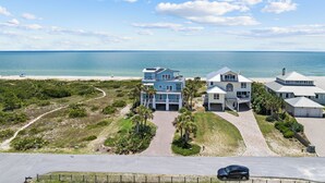A coastal property with multiple buildings, a beach view, and a clear sky. - Seven Seas: Book your stay and enjoy the Island's first Splash Pad! (St. George Island)