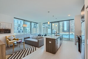 Departamento Premium, 1 habitación | Área de sala de estar | Televisión de pantalla plana de 55 pulgadas con canales por cable