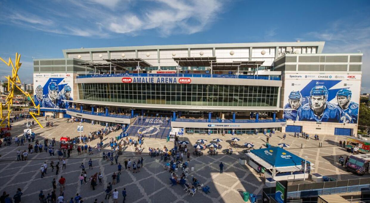 A stadium with a large entrance and a central field.