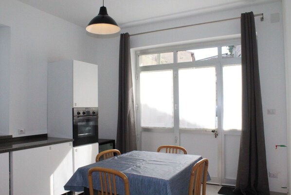Enjoy meals in this cozy kitchen with an oven and dining table for two.