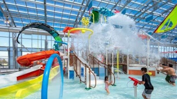 An indoor water park with slides, water jets, and play structures. - Relax by fire pit - Walk to Lake (Little Elm)