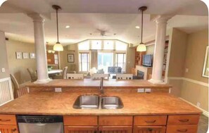 Full kitchen overlooking the dining table and living room. 