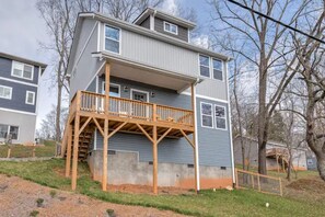 A two-story building with a wooden deck and a concrete foundation. - Hillside Hideaway Boho 3BR Home w Gameroom, Waffle Bar, Gas Fire Pit, Mtn Views! (Canton)