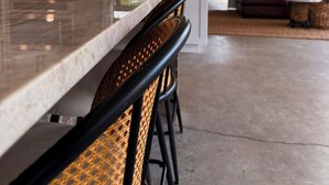 A modern kitchen with white cabinets, stainless steel appliances, and a large island with bar stools. - Sebring International Races! (Sebring)