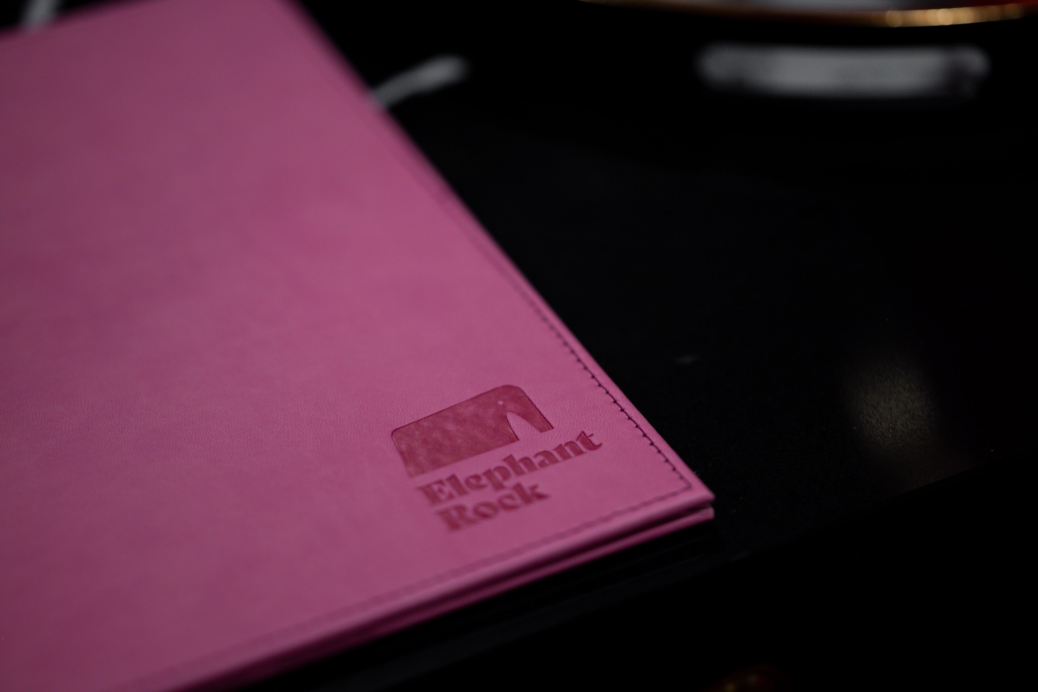 A pink notebook with the text "Elephant Rock" on it.