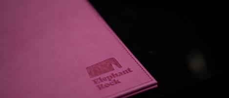 A pink notebook with the text "Elephant Rock" on it.