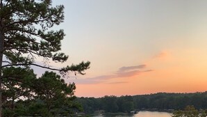 A lakeside view with a wooden dock, a stone railing, and a grassy area. - Relax & Enjoy beautiful Sunsets!  * Boating Packages Available! (Hot Springs)