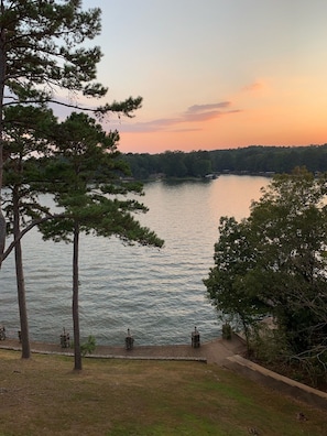 A lakeside view with a wooden dock, a stone railing, and a grassy area. - Relax & Enjoy beautiful Sunsets! * Boating Packages Available! (Hot Springs)
