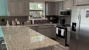 A kitchen with granite countertops, stainless steel appliances, and wooden flooring. - Relax & Enjoy beautiful Sunsets!  * Boating Packages Available! (Hot Springs)