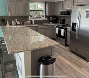 Enjoy cooking in this well-equipped kitchen with a refrigerator, oven, and microwave.