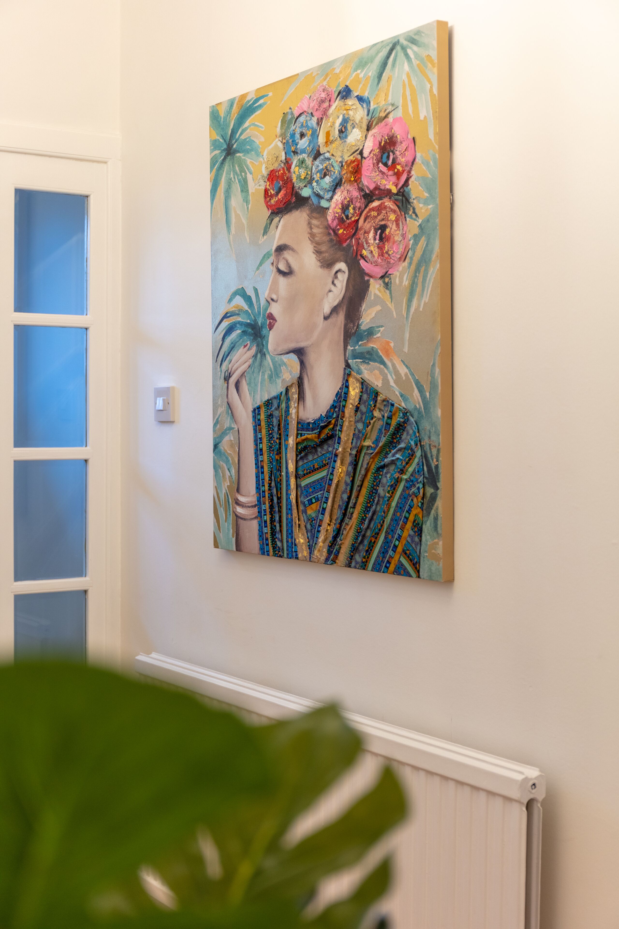 A painting of a woman with floral patterns on a wall.