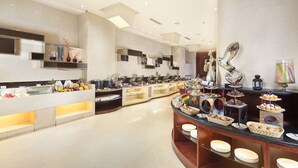 A modern buffet setup with various food stations and a central serving area. - Ramada Plaza by Wyndham Shenyang City Center (Shenyang)