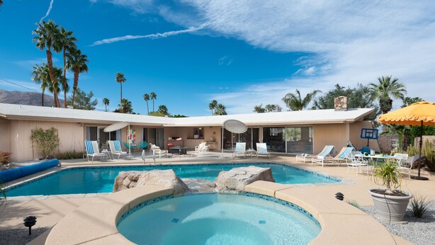 A pool area with lounge chairs, a hot tub, and palm trees. - Fully furnished Midcentury Home, 3 Bd/Den, Views, Best So PD Location (Palm Desert)