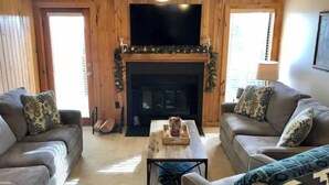 A cozy living room with two sofas, a coffee table, and a fireplace. - 11 Powderidge, Snowshoe, WV - Slopeside Serenity (Snowshoe)