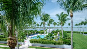 A pool area with lounge chairs and a view of the water. - Indigo Reef Resort Villas and Marina (Marathon)